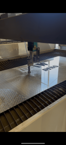 Raw Welding Inc. water jet cutting machine in use for precision metal fabrication services