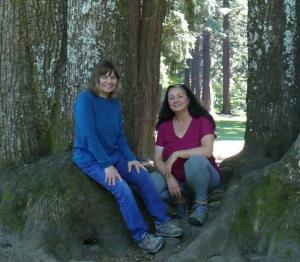 two female artists sit among the trees in the Pacific Northwest