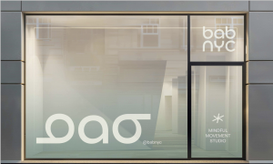 BAB NYC flagship women’s wellness studio exterior in Brooklyn, featuring mindful movement branding and logo on glass storefront.