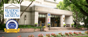 Exterior view of the Reading Public Museum, showcasing its entrance and greenery, with logos for the museum and Certified Autism Center.