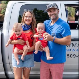 Drymaster owners Sally and Brandon Brubaker with their twins, at the Coeur D' Alene Idaho 4th of July Parade, celebrating community while showcasing their five-star home and commercial services.