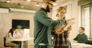 The United States had 7,840 coworking locations by Q1 2025, with coworking now accounting for 140 million square feet—approximately 2% of total national office space Two happy office workers in coworking space