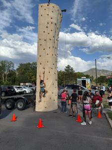 Utah Virtual Academy (UTVA) hosted its annual Back to School Fair this week at Sugar House Park, giving hundreds of kindergarten through fifth grade students the opportunity to meet their teachers and classmates in person while enjoying games, food, and activities UTVA student climbing a wall during back to school fair