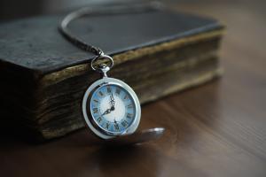 Antique Pocket Watch on Old Book Close-Up