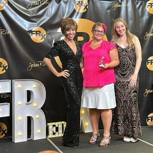 FRedx Impact Award, Forbes Riley, Katie Hornor and Makenna Riley on stage