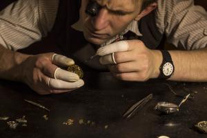 The watchmaker is repairing the mechanical watches in his workshop
