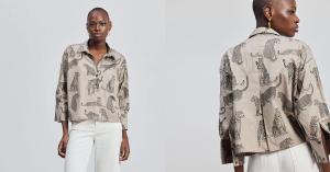 An effective alt text for the image is: "A woman wearing an oversized, cropped button-down shirt with a black and white animal print, paired with white pants.
