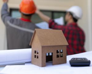 The Hardwood Galleria Design Center is proud to announce the launch of its full suite of remodeling services, now including dedicated kitchen remodeling and bathroom remodeling solutions Model of a home next to construction workers.