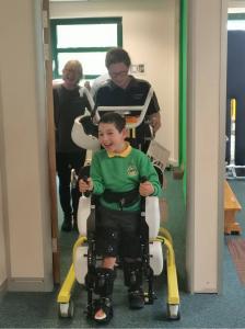 RoboCT, a leading developer of intelligent rehabilitation exoskeletons, announced a strategic collaboration with the UK-based Morrello Clinic, marking RoboCT’s official entry into the UK healthcare market Pediatric patient using a RoboCT gait-training exoskeleton at Morrello Clinic, smiling, with supportive parents nearby and a therapist supervising the session.