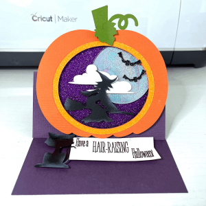 Pumpkin scene card crafted with purple glitter luxe cardstock, perfect for stylish and festive Halloween paper crafting projects.