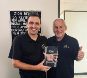 Rob Fuller and Jack Henz formally pose with the Master Design Award, accepting national recognition on behalf of the Zion Outdoors team.