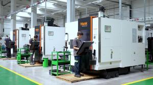 Workers using CNC machining centers inside Simsek Makina Takim factory for precision manufacturing.