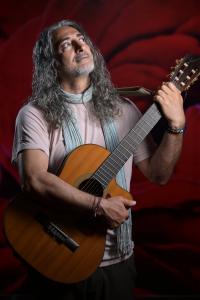 Tall man with long gray hair and guitar