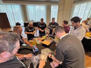 Small Comforts, Big Impact: How Argon & Co Supports Pediatric Patients & Hospital Heroes 10 A group of people wearing Argon & Co working on assembly of kits for Children's Healthcare of Atlanta for kits, caregivers and staff.