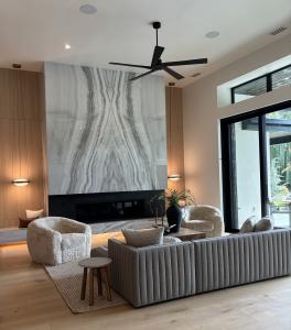 warm organic living room in custom home  Eagle Idaho featuring stone and natural wood