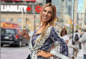 Kristine Bene smiling in the streets of Toronto, enjoying the city’s energy and the lifestyle freedom she’s built.