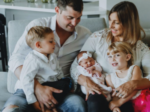Kristine Bene smiling with her husband and three children, highlighting the family lifestyle and togetherness created through Prosperity Of Life.