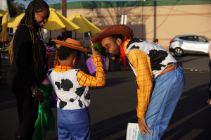Child and adult both dressed as Woody from Toy Story smiling and playing together at Bierman Autism Centers’ sensory-friendly Trunk-or-Treat event.