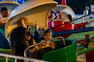 family enjoys amusement ride