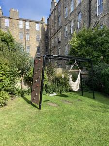 Large Black Metal Climbing Frame in customer's garden bought from Happy Hideouts