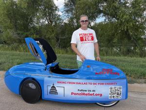 Aaron Novinger standing next to a blue human-powered velomobile, promoting a charity bike ride from Dallas to Washington, D.C. to raise awareness for Ponzi victims through PonziRelief.org