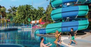 Families enjoying slides and water play at the Fun Pool, Courtyard by Marriott Phuket, Patong Beach Resort.