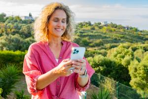 Sarah Hampel, Prosperity Of Life $50K Club achiever, smiling outdoors in nature, representing lifestyle freedom and personal growth.