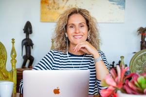 Sarah Hampel at her desk with laptop, confidently running her Prosperity Of Life business with ease and professionalism.