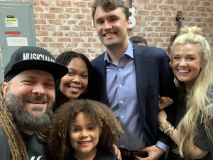 A photo of Mark and Avion of Christafari with Charlie and Erika Kirk at a Turning Point Faith Event