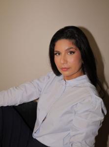 Author Rey Abadi head shot seated at desk