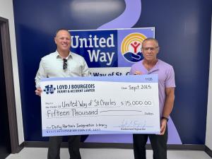 Attorney Loyd Bourgeois presents sponsorship check to United Way of St. Charles