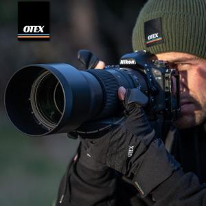 Photographer using OTEX gloves and OTEX beanie to help perform at his best