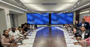 Onyx Initiative, a Toronto based non-profit established by philanthropists and serial entrepreneurs, Drs A group of Onyx Initiative students seated around a large boardroom table, smiling and waving during a corporate workshop.