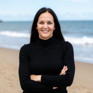 an image of a woman standing with arms folded