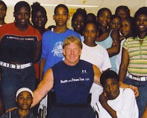 Man in a wheelchair next to a group of students.