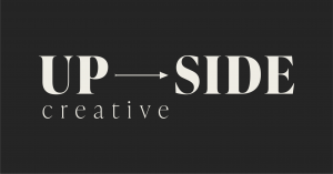 Image of Upside Creative logo, dark background with an arrow between the words Up and Side