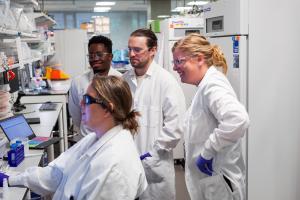 An Allen Institute wet bench team looking at immunology data. Clockwise from left: Kathy Henderson, Nelson Mukuka, Garrett Strawn and Claire Gustafson. Credit: Allen Institute
