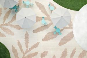 Public Space using Techo-Bloc's Industria HD2 Granitex pavers in Chestnut Brown and Beige Cream arranged in a large-scale floral motif