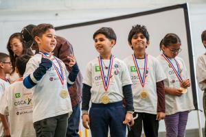 Children wearing OSCA and TD shirts proudly display their medals during the Brampton Recreational Cricket Program, celebrating youth achievement, inclusion, and active living through cricket.