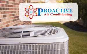 Outdoor air conditioning unit installed beside a brick wall with the Proactive Air Conditioning logo displayed in the corner, representing professional HVAC services.