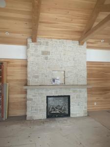 Red Robin Masonry announces the expansion of its services across Ontario to directly address the urgent and common structural problems faced by property owners, from cracked foundations to deteriorating brickwork Custom indoor stone fireplace installation by Red Robin Masonry in Toronto