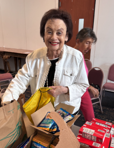 Sharon Burns packing Bags of Hope with tuna and crackers to be given to the homeless