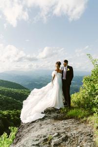 Premier North Carolina venue eliminates wedding planning stress with comprehensive package for intimate celebrations Wedding couple on Twickenham House cliffside terrace with panoramic mountain views for stunning wedding photography