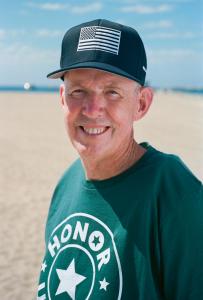 U.S.VETS, the leading nonprofit working to prevent and end veteran homelessness, today launched its 2025 Make Camo Your Cause campaign to #HONORUSVETS, naming U Sam Evans is wearing an Honor US Vets t-shirt and hat and smiling at the camera