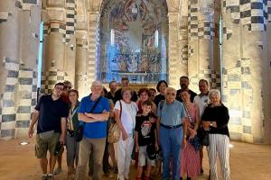 Group photo of visitors inside Abbazia di Santa Giustina Villa Badia Sezzadio in front of the frescoed apse after a guided visit in Sezzadio Piedmont Italy