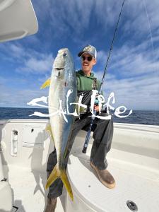 Man holding fish in Salt Life gear