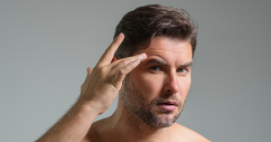 Man inspects brow lines