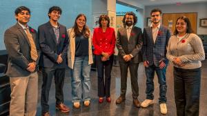 Group photo of Mississauga City Councillor Dipika Damerla in a red jacket with CoHNA Canada president Rishabh Sarswat and other Hindu community representatives, standing together outside City Council chambers