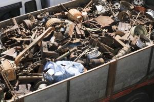 Overhead view of a large dumpster filled with assorted scrap metal materials prepared for commercial recycling