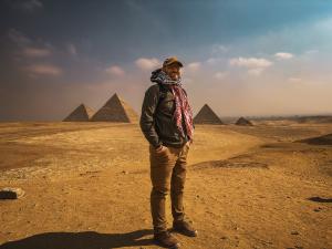 Dr. Chad Scott at the Pyramids of Giza, exploring the intersection of ancient history, cultural legacy, and reflective travel.